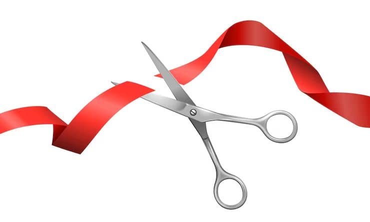 Illustration of scissors cutting through a red ribbon, symbolizing a fresh start and the decisive moment of making a well-informed loan decision.